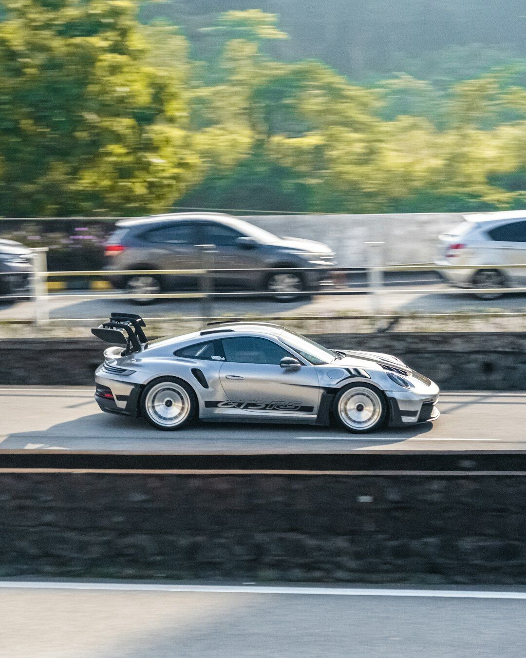 luxury sports car driving on highway