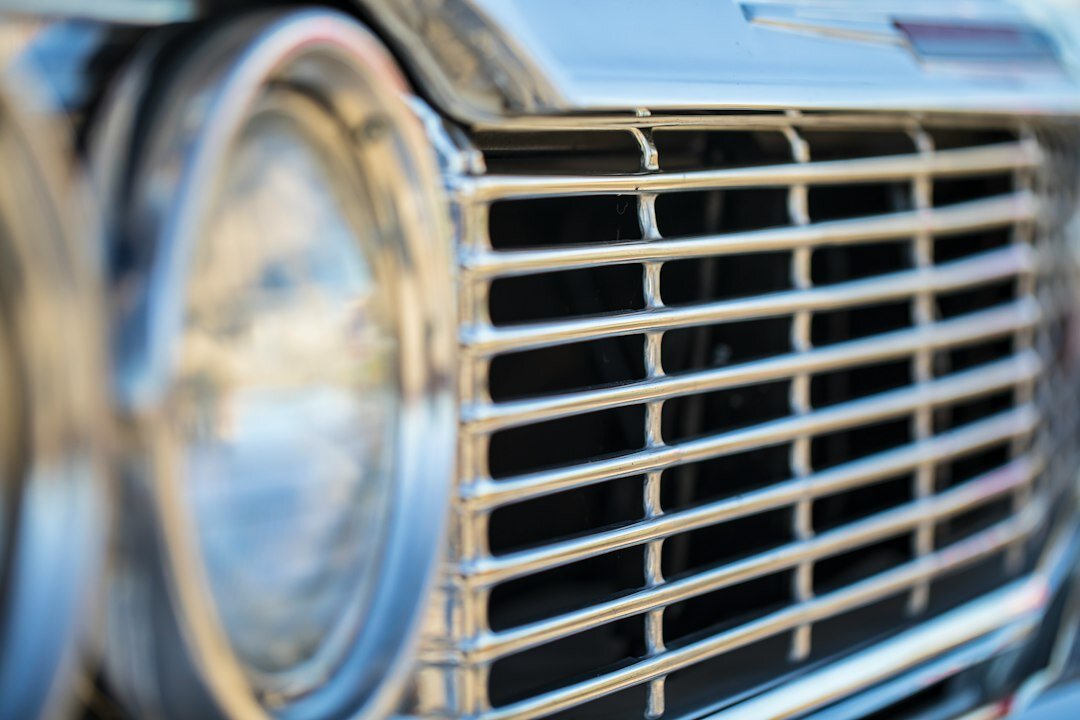 Close-up detail of a vintage automobile chrome grille and headlights