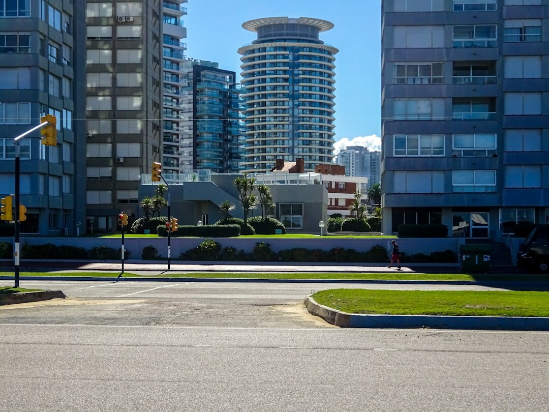 Luxury vintage automobile parked near a modern beachfront building in Punta del Este