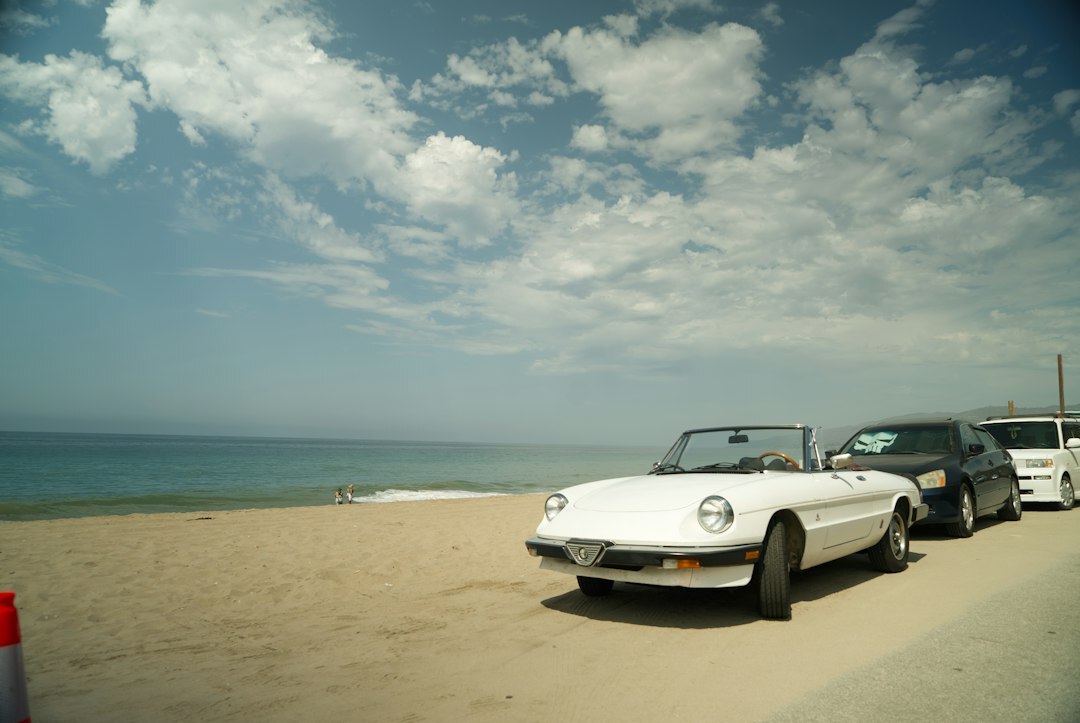 Convertible classic car parked on the beach road of Punta del Este in summer