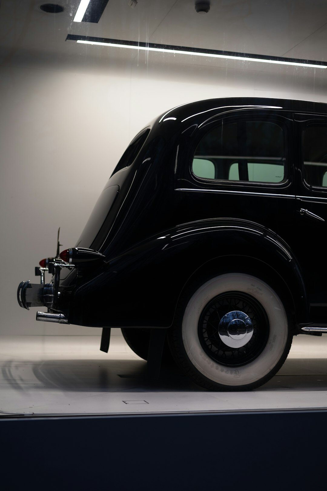Three-quarter studio view of a restored vintage automobile on a turntable