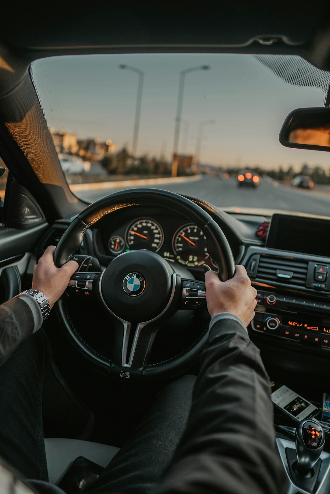 person driving luxury car