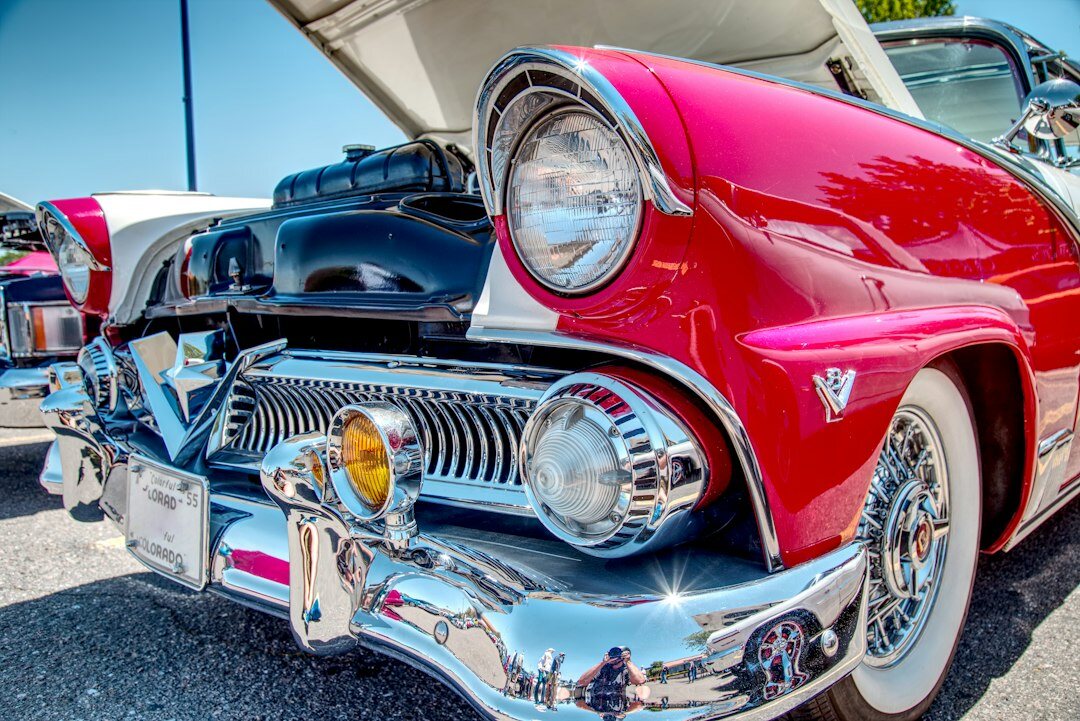 Rows of classic and vintage automobiles displayed at an exhibition hall