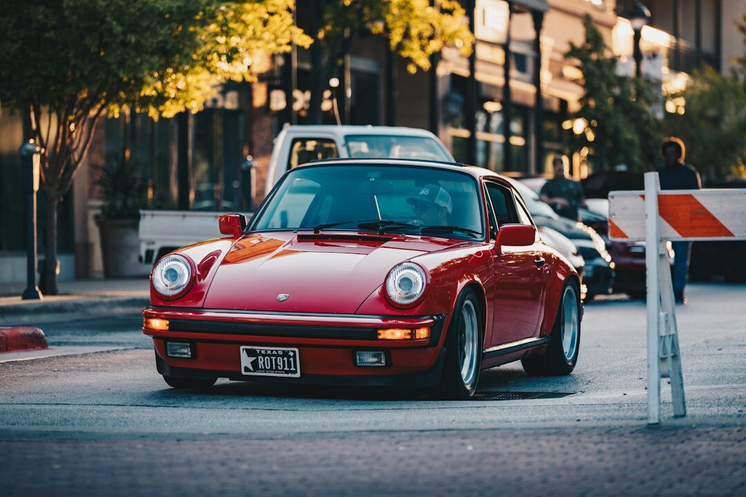 shiny red sports car on road