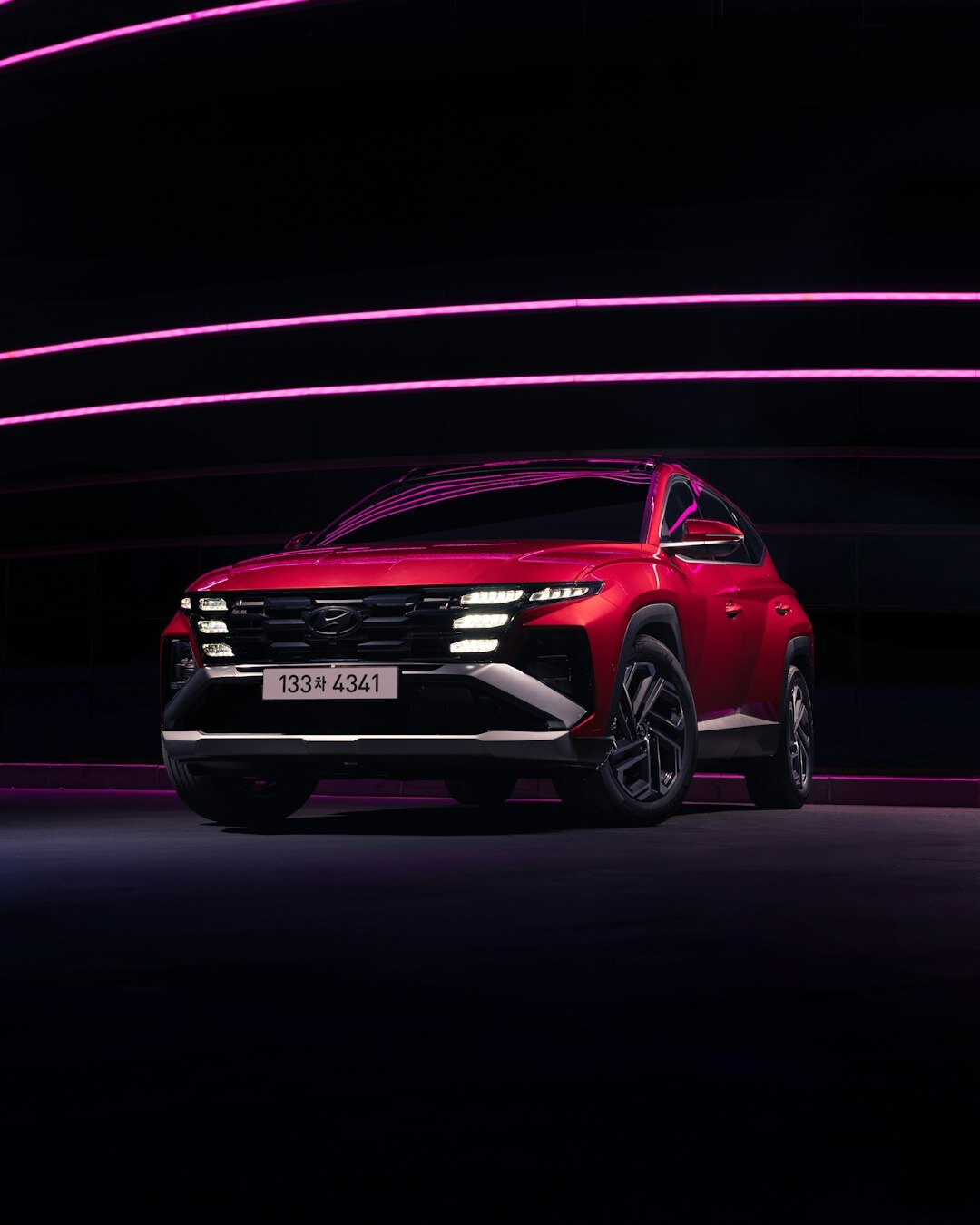 Modern hypercar photographed in a dark studio with dramatic lighting